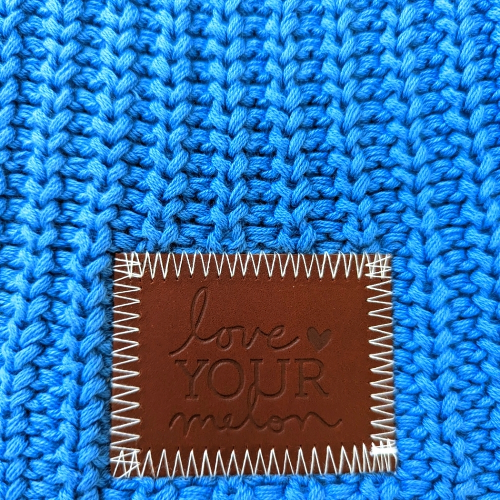 Beautiful blue LIMITED EDITION LYM beanie. Brown leather logo. NWT